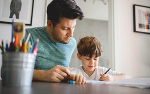 a father and son utilizing applied behavior analysis resources